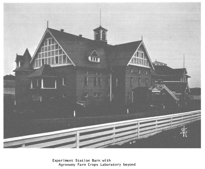 Black and white photograph of Experiment Station barn with Agronomy Farm Crops Laboratory beyond