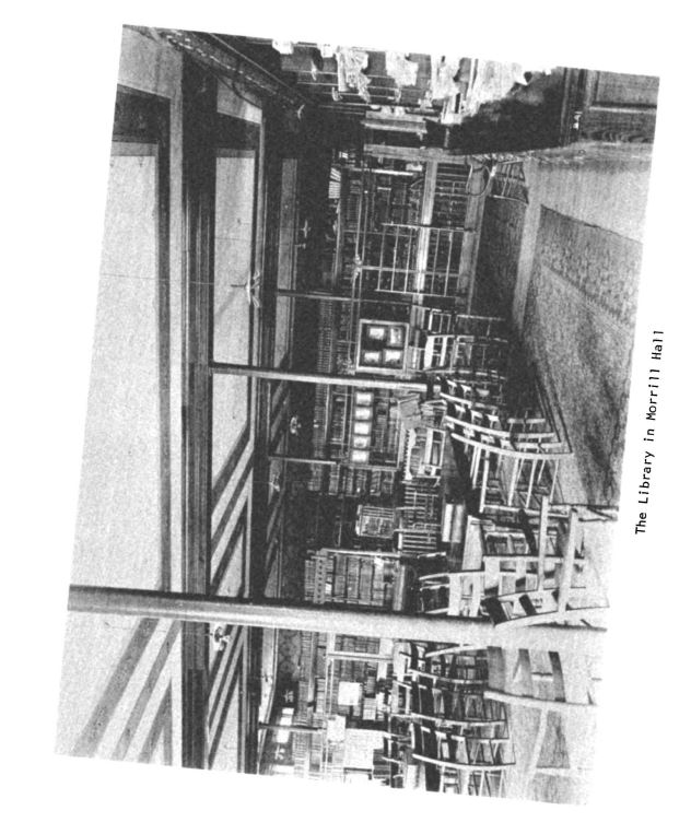 Black and white photograph of interier room of the Library in Morrill Hall